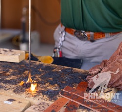 Branding iron closeup · smoke and flame